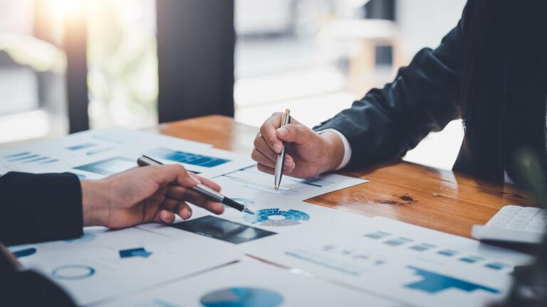 Close-up of business people analyzing chart and graph showing ch